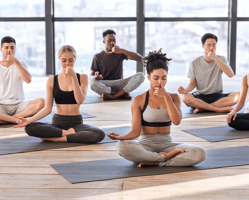 A group of people practicing yoga breathing