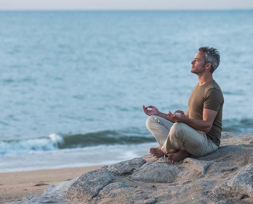 Vedic meditaion - a man meditation on the beach